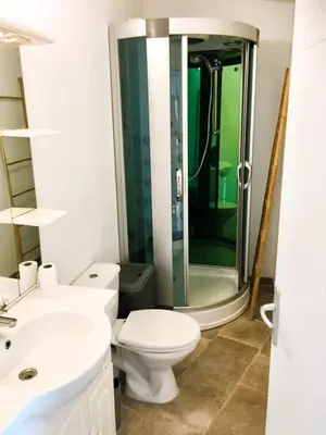 a bathroom with a toilet and a glass shower at Gîte Piscine in Narbonne