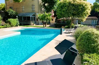 a swimming pool in front of a house at Gîte Piscine in Narbonne