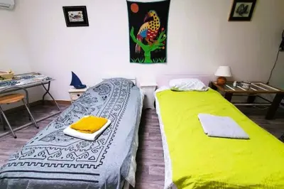 two beds sitting next to each other in a room at L'Occitane Maison de village climatisée in Lapalme