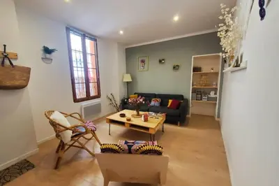 a living room with a couch and a table at La Louve in Narbonne