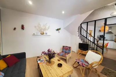 a living room with a couch and a table at La Louve in Narbonne