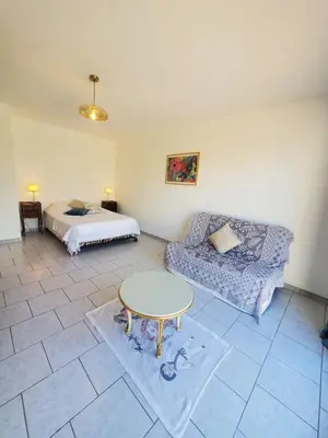 a living room with a couch and a table at L'amandier - Maison avec jardin sans vis à vis in Port-la-Nouvelle