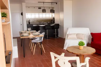 a living room with a red couch and a table at La Perle de la Mer in Port-la-Nouvelle