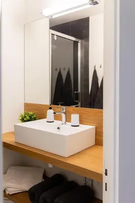 a bathroom with a white sink and a mirror at La Perle de la Mer in Port-la-Nouvelle