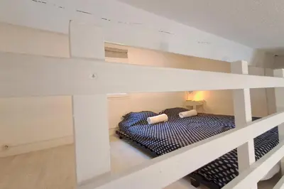 a white bunk bed in a white room at L'Escapade ensoleillée - Pavillon pour 4 in Port-la-Nouvelle