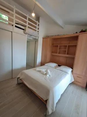 a bedroom with a bed with two towels on it at L'Escapade ensoleillée - Pavillon pour 4 in Port-la-Nouvelle