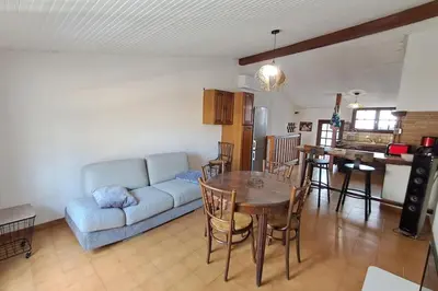 a living room with a couch and a table at L'Echo des étangs in Peyriac-de-Mer