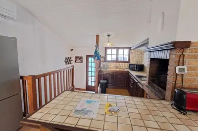 a kitchen with a tiled floor and a counter top at L'Echo des étangs in Peyriac-de-Mer