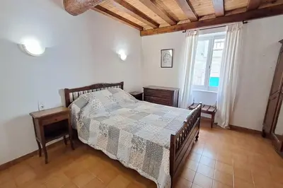 a bedroom with a bed and a window at L'Echo des étangs in Peyriac-de-Mer