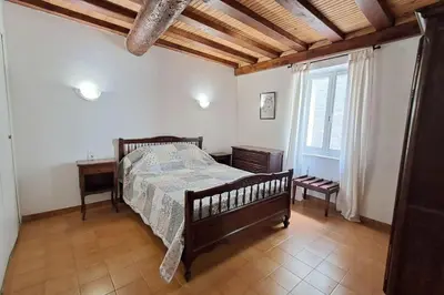 a bedroom with a bed and a wooden ceiling at L'Echo des étangs in Peyriac-de-Mer