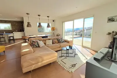 a living room with a couch and a table at Villa Famara in Montredon