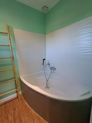 a bath tub in a room with a ladder at Villa Famara in Montredon