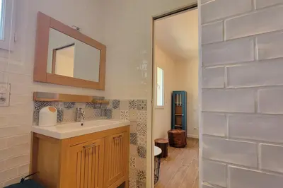 a bathroom with a sink and a mirror at Villa Famara in Montredon