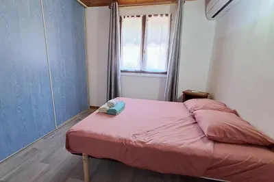 a small bed in a small room with a window at L'évasion des Corbières in Portel-des-Corbières
