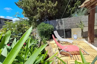 a patio with two chairs and a table and two chairs at L'évasion des Corbières in Portel-des-Corbières