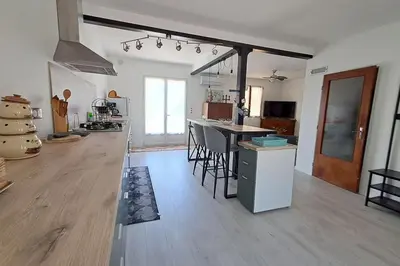 a large kitchen with a counter and a kitchen island at L'évasion des Corbières in Portel-des-Corbières