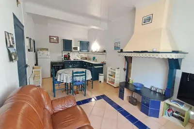 a living room with a couch and a table at La Glycine in Portel-des-Corbières
