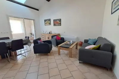 a living room with couches and chairs and a table at La Glycine in Portel-des-Corbières
