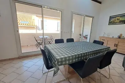 a dining room with a table and chairs in a room at La Glycine in Portel-des-Corbières