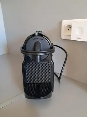 a black appliance sitting on a counter next to a wall at L'Olympe - Appartement cosy à 2 pas des Halles in Narbonne