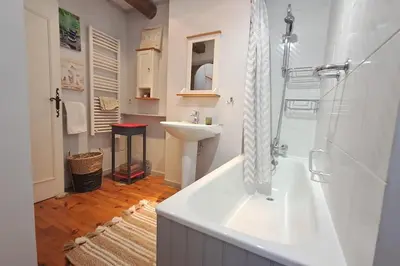 a bathroom with a tub and a sink and a shower at Cigale piscine et jardin sans vis à vis in Fontcouverte