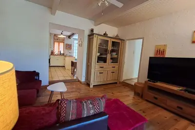 a living room with a couch and a flat screen tv at Cigale piscine et jardin sans vis à vis in Fontcouverte