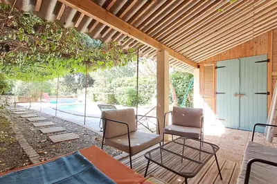 a patio with two chairs and a table at Cigale piscine et jardin sans vis à vis in Fontcouverte
