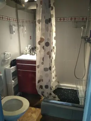 a bathroom with a shower with a toilet and a sink at Les maisons sur la plage in Gruissan
