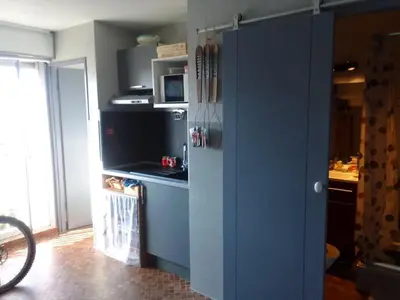a kitchen with a blue refrigerator in a room at Les maisons sur la plage in Gruissan