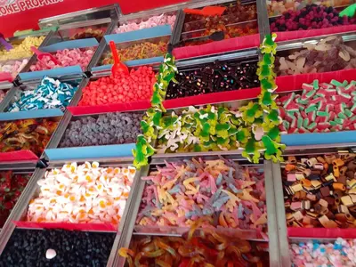 a display of different colored candies in a market at Les maisons sur la plage in Gruissan