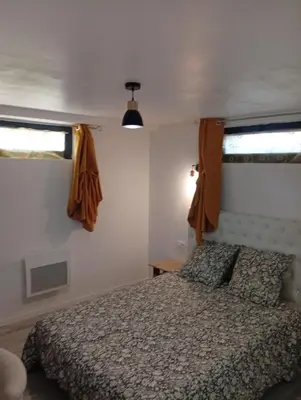 a bedroom with a bed and a window at Grand logement en souplex entier in Castres