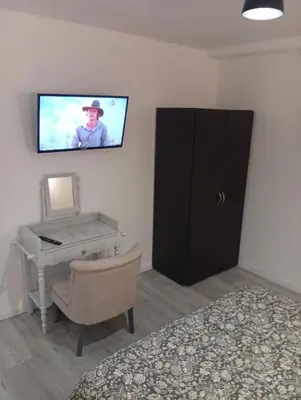 a bedroom with a desk and a tv on the wall at Grand logement en souplex entier in Castres