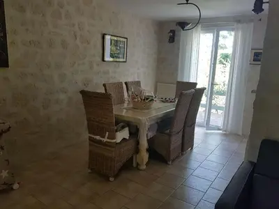 a dining room with a table and wicker chairs at Holiday Home Charmante 3 Villa La Milouyette by Interhome in Peyriac-Minervois
