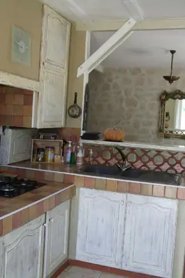 a kitchen with white cabinets and a counter top at Holiday Home Charmante 3 Villa La Milouyette by Interhome in Peyriac-Minervois