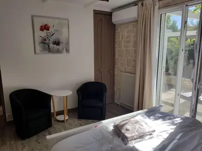 a bedroom with a bed and a table and chairs at Holiday Home Charmante 3 Villa La Milouyette by Interhome in Peyriac-Minervois