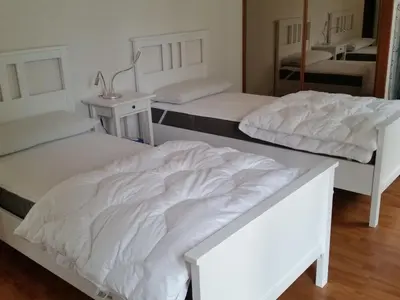 two beds in a room with two tables at Holiday Home Charmante 3 Villa La Milouyette by Interhome in Peyriac-Minervois