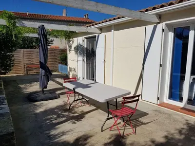 a table and two chairs and an umbrella on a patio at Holiday Home Charmante 3 Villa La Milouyette by Interhome in Peyriac-Minervois
