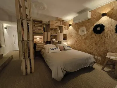 a bedroom with a bed with love pillows on it at Un duplex pas comme les autres in Carcassonne