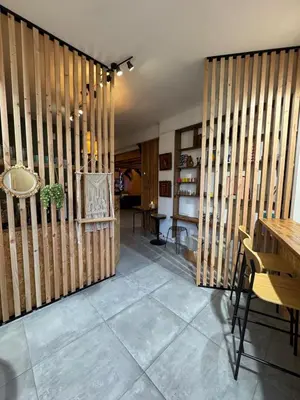 a room with wooden walls and a table and chairs at Un duplex pas comme les autres in Carcassonne