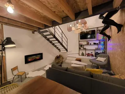 a living room with a couch and a fireplace at Un duplex pas comme les autres in Carcassonne