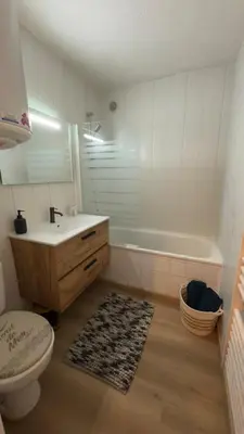 a bathroom with a sink and a toilet and a tub at Studio cosy au bord du port à proximité de tout commerce in Gruissan