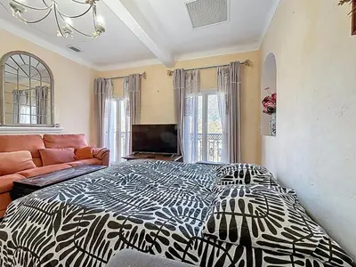 a bedroom with a zebra print bed and a couch at Le Mirabeau - Appartement bourgeois - Terrasse 80m2 - Wifi et Climatisation in Narbonne