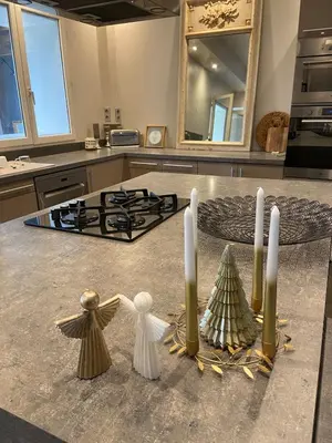 a kitchen counter with three candles and a christmas tree at L'Échappée Belle 3 étoiles - Piscine, Jardin et Pool-house - Proche Cité in Carcassonne