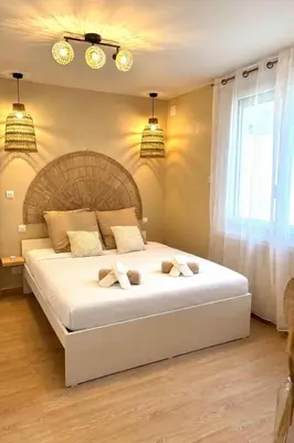 a bedroom with a large white bed with two pillows at Suite Bali et sauna privé - vidéo projecteur - escapade romantique-centre in Carcassonne