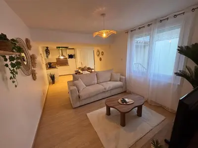 a living room with a couch and a table at Suite Bali et sauna privé - vidéo projecteur - escapade romantique-centre in Carcassonne