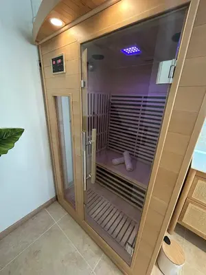 a glass door of a shower in a room at Suite Bali et sauna privé - vidéo projecteur - escapade romantique-centre in Carcassonne