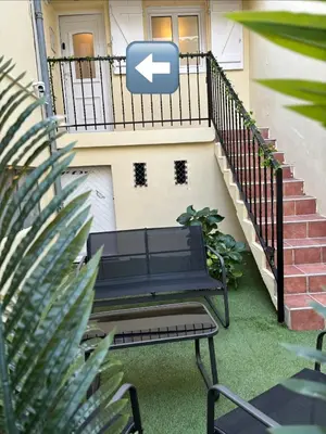 a bench in front of a house with a staircase at Suite Bali et sauna privé - vidéo projecteur - escapade romantique-centre in Carcassonne