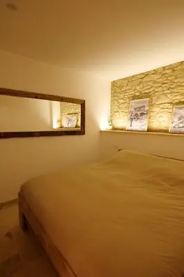a bedroom with a bed and a mirror at Gîte La Choule in Mourvilles-Hautes