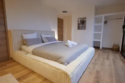 a bedroom with a large bed with a wicker frame at Gîte La Choule in Mourvilles-Hautes