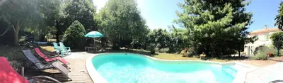 a swimming pool in a yard next to a house at Gîte Au Coeur Du Pays Cathare in Fanjeaux
